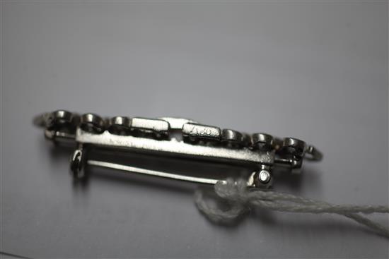 A mid 20th century Cartier platinum and diamond bar brooch, 36mm.